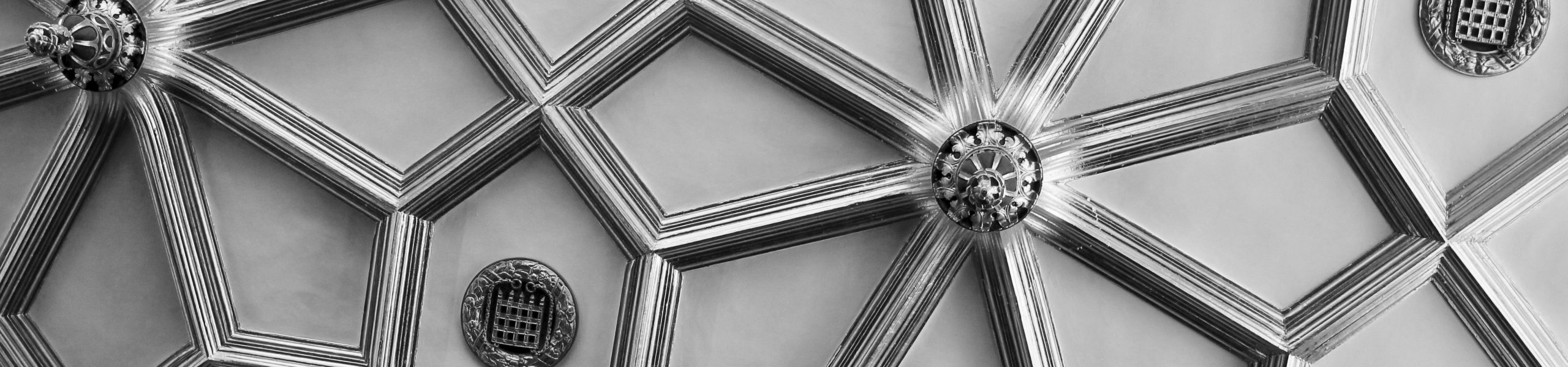 Family trust hero image of embellished ceiling with black and white filter