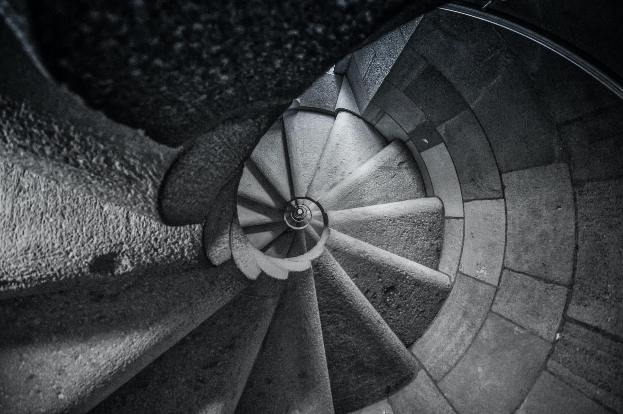 Step plan hero image of birds eye view of spiral stair case with black and white filter