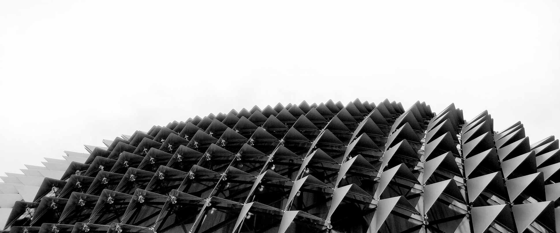 Venture capital fund hero image of scale like metal roof structure with black and white filter